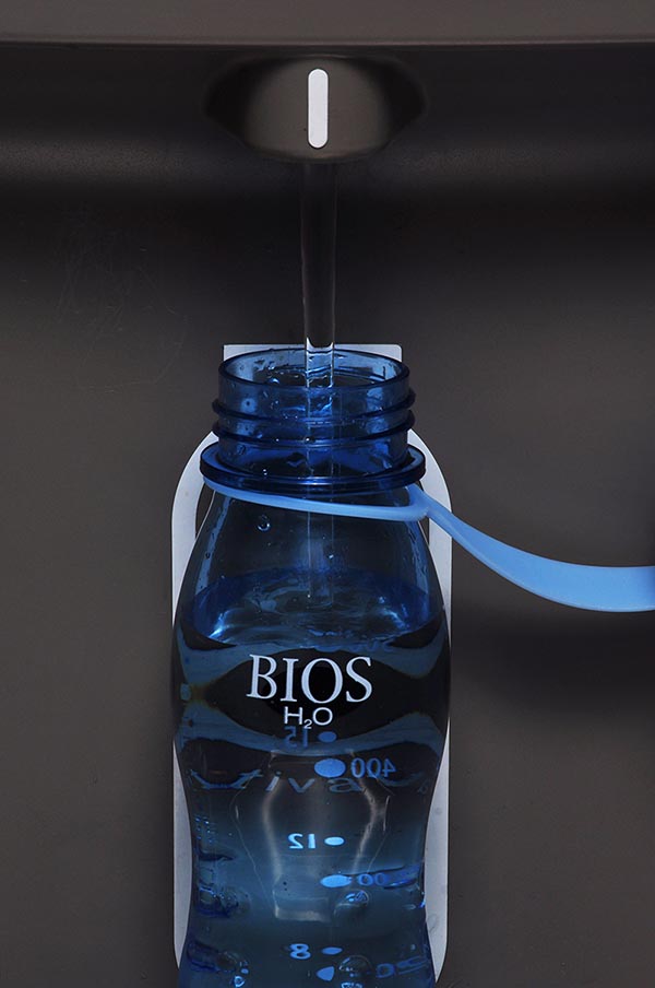 Closeup of a reusable water bottle getting refilled.