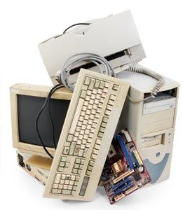 EWaste Pile - Old computer desktop, keyboard, and motherboard.