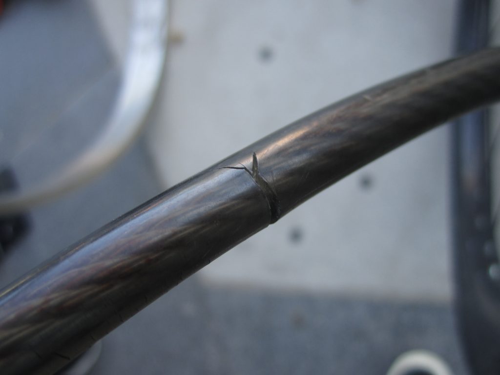 Closeup of a bike lock wire with an attempted but unsuccessful theft. The wire has a deep cut from cutters, but has not made it through.